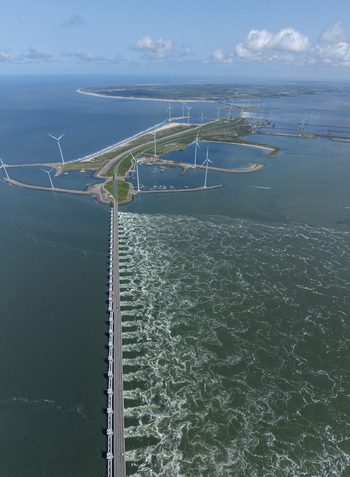 Aerial view of the Eastern Scheldt Storm Surge Barrier with turbulent water flowing through the gates wind turbines and coastal landscape in Vrouwenpolder Zeeland Netherlands. Aerial view of the Eastern Scheldt Storm Surge Barrier with turbulent water flowing through the gates wind turbines and coastal landscape in Vrouwenpolder Zeeland Netherlands.