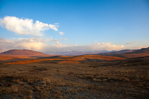 View of Deosai National Park featuring vast golden plains and rolling hills under a clear blue sky in Astore Gilgit Pakistan. View of Deosai National Park featuring vast golden plains and rolling hills under a clear blue sky in Astore Gilgit Pakistan.