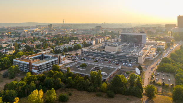 Aerial view of the Czech Television headquarters complex with modern buildings satellite dishes and parking areas surrounded by lush greenery in Prague Hlavni mesto Praha Czechia. Aerial view of the Czech Television headquarters complex with modern buildings satellite dishes and parking areas surrounded by lush greenery in Prague Hlavni mesto Praha Czechia.