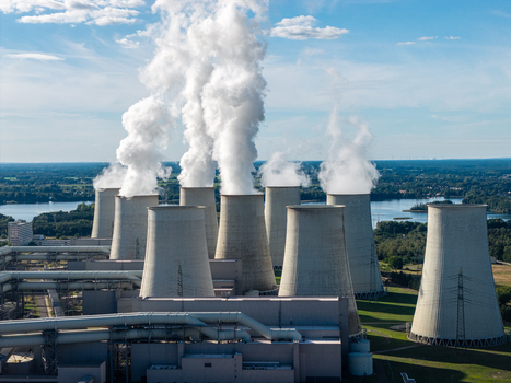 Aerial view of the Janschwalde Power Station with its large cooling towers emitting steam plumes into a clear blue sky in Peitz Brandenburg Germany. Aerial view of the Janschwalde Power Station with its large cooling towers emitting steam plumes into a clear blue sky in Peitz Brandenburg Germany.