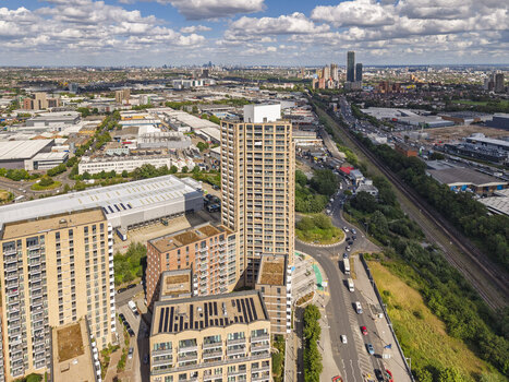 Aerial view of modern residential high rise buildings surrounded by urban infrastructure a railway line and roads in London England United Kingdom. Aerial view of modern residential high rise buildings surrounded by urban infrastructure a railway line and roads in London England United Kingdom.