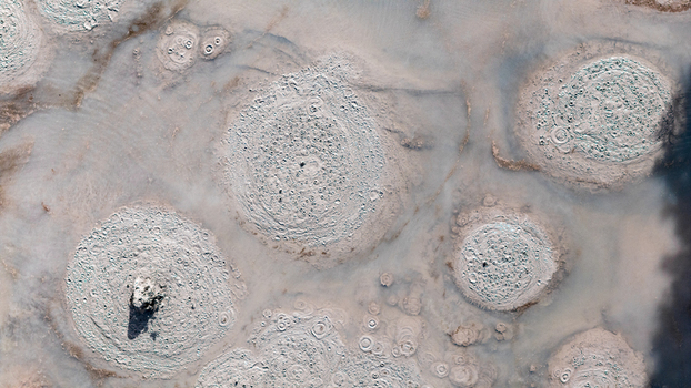 Aerial view of striking circular formations in a geothermal landscape showcasing textured patterns and earthy tones Waiotapu Thermal Wonderland Waikato Region New Zealand. Aerial view of striking circular formations in a geothermal landscape showcasing textured patterns and earthy tones Waiotapu Thermal Wonderland Waikato Region New Zealand.