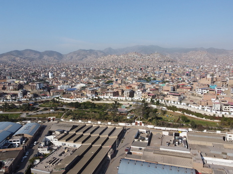 Aerial view of the dense urban landscape of San Juan de Miraflores featuring residential neighborhoods industrial warehouses and distant hills in San Juan de Miraflores Lima Peru. Aerial view of the dense urban landscape of San Juan de Miraflores featuring residential neighborhoods industrial warehouses and distant hills in San Juan de Miraflores Lima Peru.