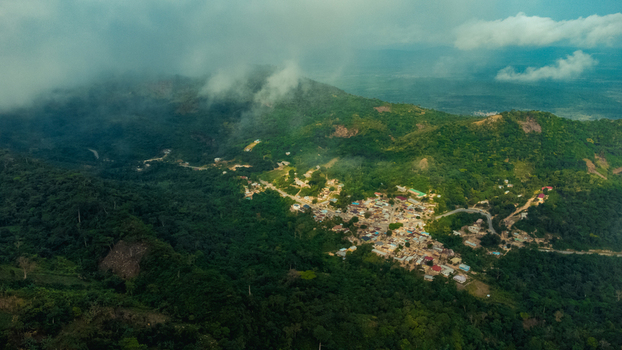 Aerial view of Mt. Gemi and the village of Amedzofe nestled among lush green mountains with clouds and winding roads in Amedzofe Volta Region Ghana. Aerial view of Mt. Gemi and the village of Amedzofe nestled among lush green mountains with clouds and winding roads in Amedzofe Volta Region Ghana.