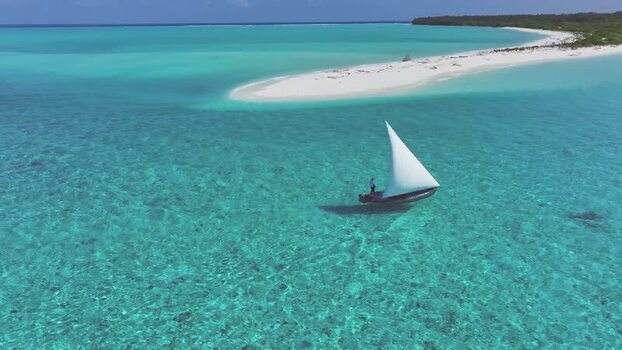 Aerial view of a traditional sailboat near a sandbank Maldives. Aerial view of a traditional sailboat near a sandbank Maldives.