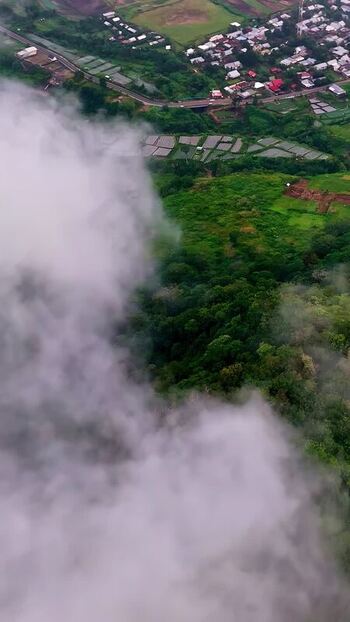 Aerial view of lush green hills and village in Bali Indonesia.
