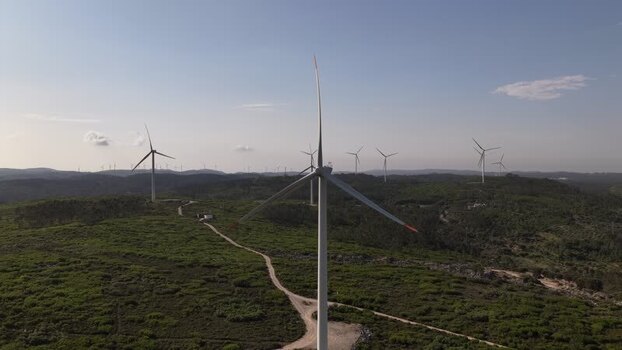 Aerial view of wind turbines on green hills in Pombal Portugal. Aerial view of wind turbines on green hills in Pombal Portugal.