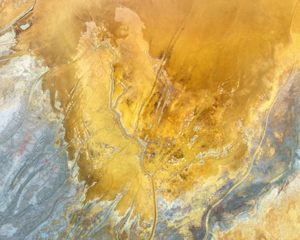 Aerial view of the abstract mineral patterns and oxidized yellow soil at the historic open pit mine Minas de Riotinto Andalusia Spain.