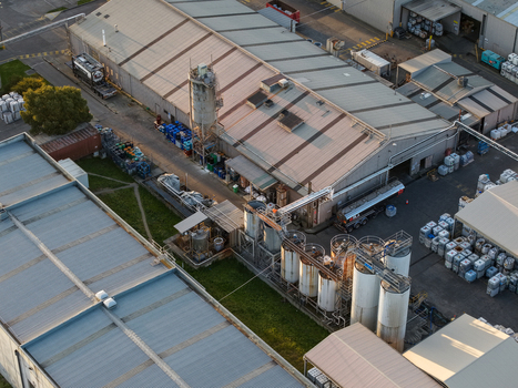 Melbourne VIC Australia 22 September 2026 Aerial view of the industrial facility in Kilsyth featuring metal storage tanks corrugated factory roofs and tanker trucks. Melbourne VIC Australia 22 September 2026 Aerial view of the industrial facility in Kilsyth featuring metal storage tanks corrugated factory roofs and tanker trucks.