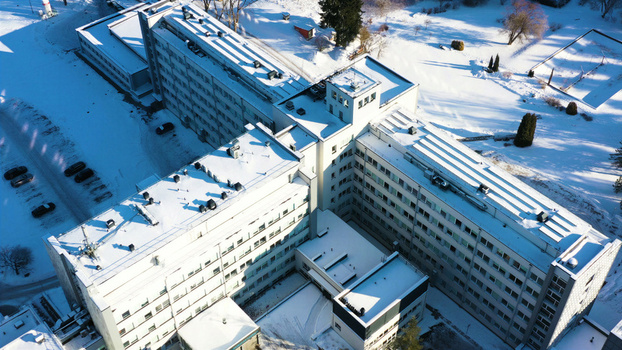 Aerial view of Vidzeme Hospital surrounded by snow covered grounds and parking areas in Valmiera Latvia. Aerial view of Vidzeme Hospital surrounded by snow covered grounds and parking areas in Valmiera Latvia.
