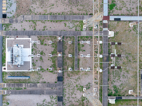 Aerial view of a high voltage main inlet substation with metal transmission towers concrete walkways and gravel ground in Central Seberang Perai Penang Malaysia. Aerial view of a high voltage main inlet substation with metal transmission towers concrete walkways and gravel ground in Central Seberang Perai Penang Malaysia.