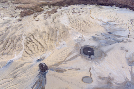 Aerial view of the Mud Volcanoes of Paclele Mari showing grey mud craters textured soil patterns and eroded landscape in Paclele Buzau County Romania.
