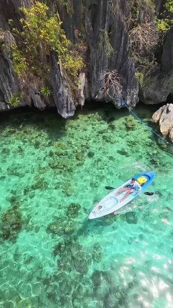 FPV aerial view of kayaker in Coron Philippines.