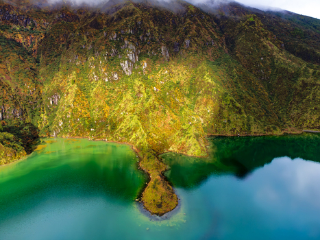 Aerial view of Lagoa do Fogo crater lake with lush green volcanic slopes and turquoise water in Agua de Alto Azores Portugal. Aerial view of Lagoa do Fogo crater lake with lush green volcanic slopes and turquoise water in Agua de Alto Azores Portugal.