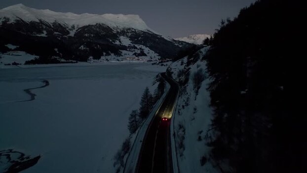 Aerial view of road along frozen Reschensee in Graun im Vinschgau Italy. Aerial view of road along frozen Reschensee in Graun im Vinschgau Italy.