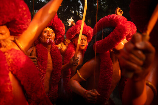 Munshiganj Bangladesh 13 April 2025 View of devotees adorned in vibrant crimson garlands and golden turmeric paste their intense expressions illuminated by warm light during a captivating ritual. Munshiganj Bangladesh 13 April 2025 View of devotees adorned in vibrant crimson garlands and golden turmeric paste their intense expressions illuminated by warm light during a captivating ritual.