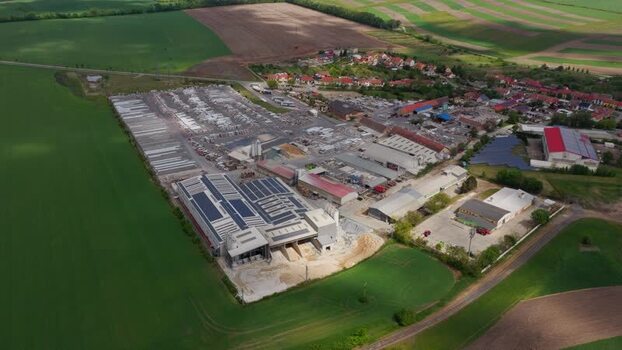Aerial view of an industrial complex and green fields in Czechia. Aerial view of an industrial complex and green fields in Czechia.