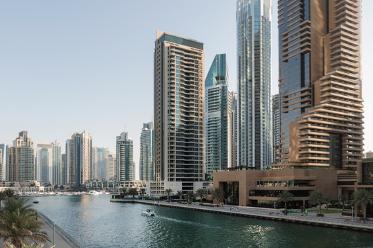 View of shimmering waterways reflecting the towering skyscrapers a symphony of glass and steel reaching for the sky in Dubai Dubai United Arab Emirates. View of shimmering waterways reflecting the towering skyscrapers a symphony of glass and steel reaching for the sky in Dubai Dubai United Arab Emirates.