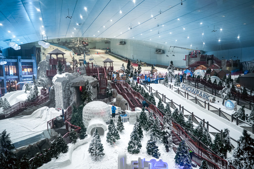 Dubai United Arab Emirates 20 April 2023 View of Ski Dubai featuring indoor ski slopes snowy terrain pine trees and an igloo under bright artificial lighting. Dubai United Arab Emirates 20 April 2023 View of Ski Dubai featuring indoor ski slopes snowy terrain pine trees and an igloo under bright artificial lighting.