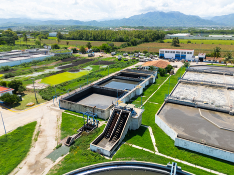 Aerial view of industrial water treatment plant and green fields under a sky with scattered clouds Puerto Vallarta Mexico. Aerial view of industrial water treatment plant and green fields under a sky with scattered clouds Puerto Vallarta Mexico.