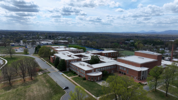 Aerial view of E.C. Glass High School campus in spring with red brick buildings green lawns and athletic fields in Lynchburg Virginia United States.