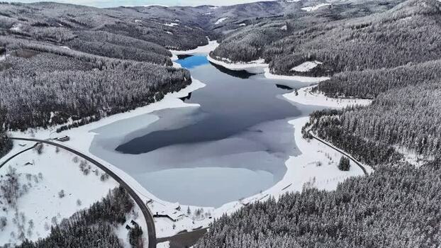 Aerial view of frozen Soboth Reservoir in Weststeiermark Austria.