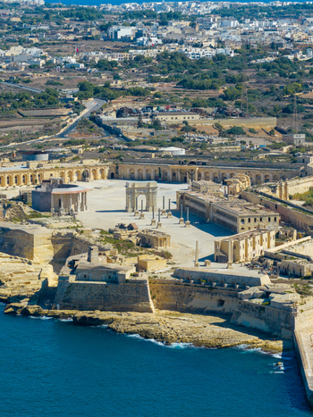 Aerial view of Fort Manoel a historic star shaped fortification on Manoel Island with stone walls and a central parade ground overlooking the Mediterranean sea in Valletta Port Region Malta. Aerial view of Fort Manoel a historic star shaped fortification on Manoel Island with stone walls and a central parade ground overlooking the Mediterranean sea in Valletta Port Region Malta.
