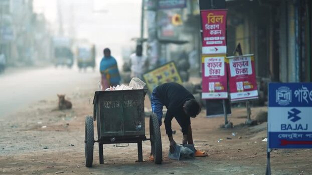 View of a man with a handcart on a street in Bogura Bangladesh. View of a man with a handcart on a street in Bogura Bangladesh.