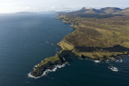 Aerial view of The Brother s Point with rugged cliffs and the blue sea under a clear sky in Culnacnoc Scotland United Kingdom. Aerial view of The Brother s Point with rugged cliffs and the blue sea under a clear sky in Culnacnoc Scotland United Kingdom.