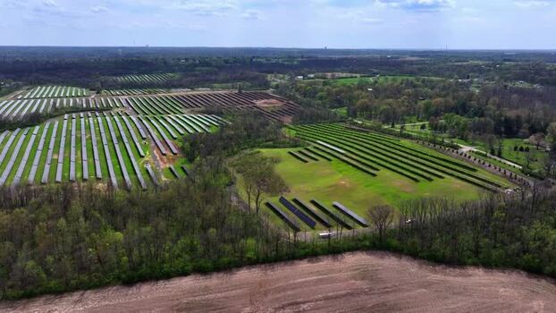 Aerial view of solar farm panels surrounded by green fields United States. Aerial view of solar farm panels surrounded by green fields United States.