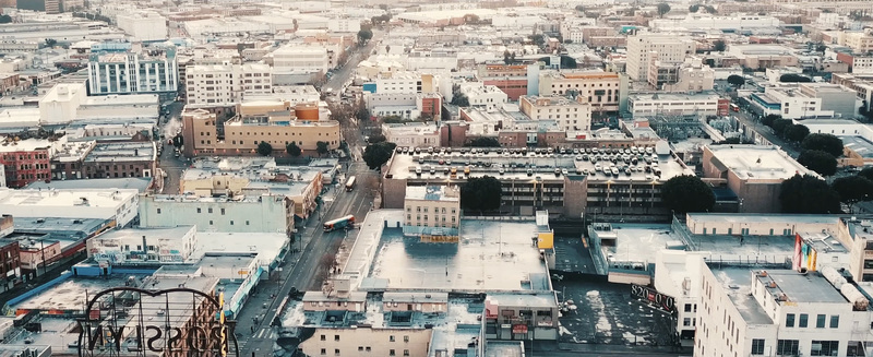 Aerial view of the dense urban landscape of downtown Los Angeles featuring historic buildings parking structures and city streets in Los Angeles California United States.