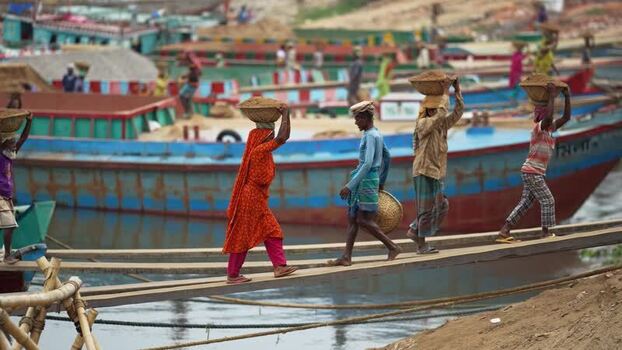 View of workers carrying baskets at Aminbazar Bangladesh. View of workers carrying baskets at Aminbazar Bangladesh.