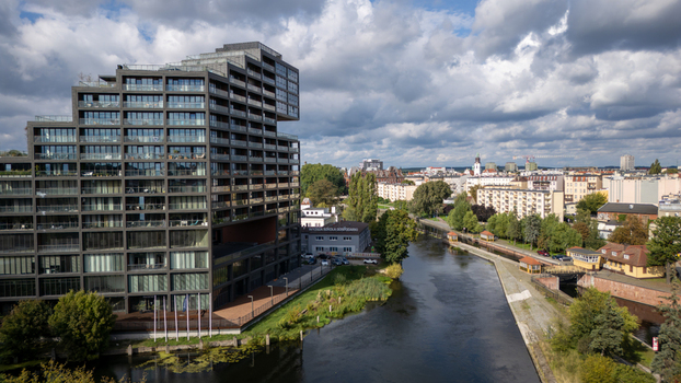 Aerial view of the modern Mennica building reflecting light near the Brda river against a backdrop of a cityscape under a cloudy sky Bydgoszcz Województwo kujawsko pomorskie Poland. Aerial view of the modern Mennica building reflecting light near the Brda river against a backdrop of a cityscape under a cloudy sky Bydgoszcz Województwo kujawsko pomorskie Poland.