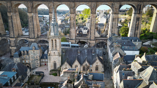 Aerial view of the Eglise Saint Melaine de Morlaix and the historic stone viaduct arches overlooking the old town rooftops in Morlaix Bretagne France. Aerial view of the Eglise Saint Melaine de Morlaix and the historic stone viaduct arches overlooking the old town rooftops in Morlaix Bretagne France.