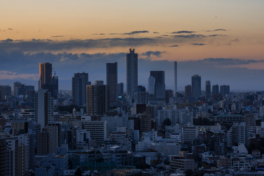Aerial view of the Tokyo skyline at dusk with illuminated skyscrapers and dense urban architecture in Tokyo Japan. Aerial view of the Tokyo skyline at dusk with illuminated skyscrapers and dense urban architecture in Tokyo Japan.
