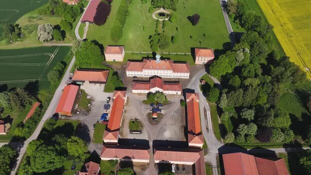 Aerial view of a historic estate with red roofs and green fields Germany. Aerial view of a historic estate with red roofs and green fields Germany.