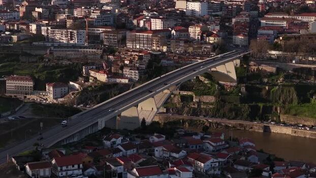 Aerial view of cars passing bridge over Douro River Portugal.