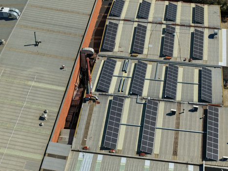 Aerial view of industrial factory rooftops featuring extensive solar panel arrays and ventilation systems in Kilsyth Victoria Australia. Aerial view of industrial factory rooftops featuring extensive solar panel arrays and ventilation systems in Kilsyth Victoria Australia.
