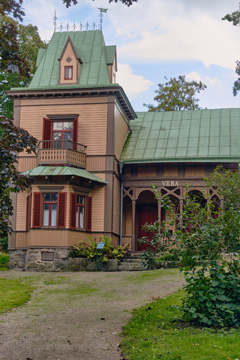 Ronneby Blekinge County Sweden 11 September 2025 View of the historic Villa Vera in Brunssparken featuring ornate 19th century wooden architecture and a green metal roof. Ronneby Blekinge County Sweden 11 September 2025 View of the historic Villa Vera in Brunssparken featuring ornate 19th century wooden architecture and a green metal roof.