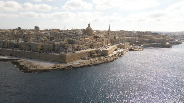 Aerial view of the historic city with its iconic dome ancient stone fortifications and coastal waterfront in Valletta Port Region Malta. Aerial view of the historic city with its iconic dome ancient stone fortifications and coastal waterfront in Valletta Port Region Malta.