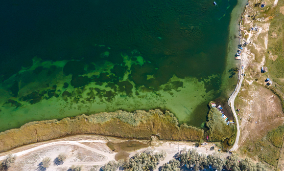 Aerial view of Blind Lake Sarfaranga Shigar with its clear green waters sandy shoreline and surrounding vegetation in Skardu Gilgit Pakistan.