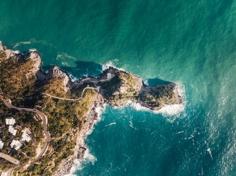 Aerial view of the rugged coastline meeting the turquoise sea in a dramatic clash of textures and tones Sorrento Campania Italy. Aerial view of the rugged coastline meeting the turquoise sea in a dramatic clash of textures and tones Sorrento Campania Italy.
