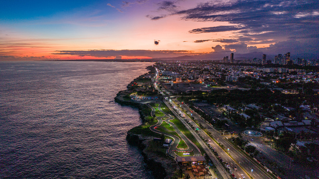 Aerial view of Feria Ganadera along the coastline at sunset with the city skyline and Caribbean Sea in Santo Domingo Distrito Nacional Dominican Republic. Aerial view of Feria Ganadera along the coastline at sunset with the city skyline and Caribbean Sea in Santo Domingo Distrito Nacional Dominican Republic.