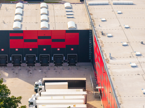 Aerial view of a modern logistics center with loading docks numbered bays and parked semi trucks in Kowale Pomeranian Voivodeship Poland. Aerial view of a modern logistics center with loading docks numbered bays and parked semi trucks in Kowale Pomeranian Voivodeship Poland.