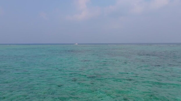 Aerial view of boat at sea near the coast Maldives.