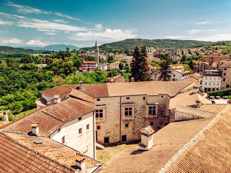 Aerial view of the historic Pazin Castle with its terracotta rooftops and stone walls overlooking the town and lush green hills in Pazin Istria County Croatia.