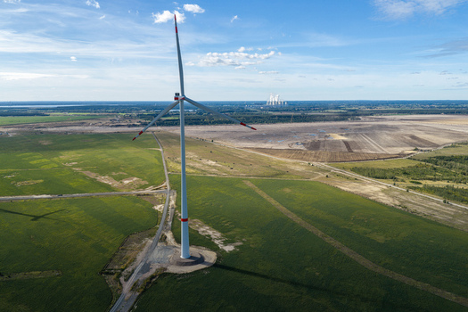 Aerial view of a wind turbine at Windpark Forst Briesnig II on recultivated land of the former Janschwalde open pit mine with the Janschwalde Power Plant in Forst Brandenburg Germany. Aerial view of a wind turbine at Windpark Forst Briesnig II on recultivated land of the former Janschwalde open pit mine with the Janschwalde Power Plant in Forst Brandenburg Germany.