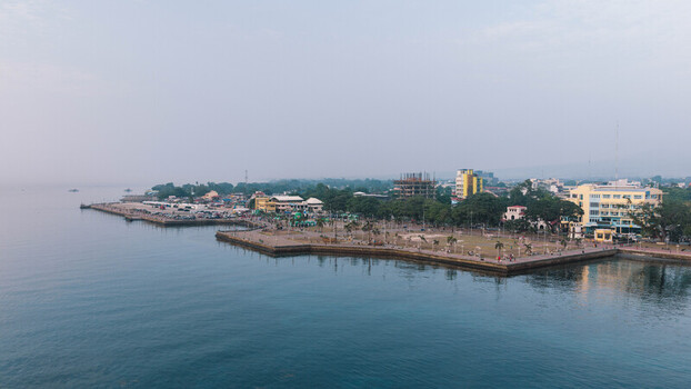 Aerial view of Rizal Boulevard along the waterfront with palm trees promenade and urban buildings in Dumaguete City Negros Island Region Philippines. Aerial view of Rizal Boulevard along the waterfront with palm trees promenade and urban buildings in Dumaguete City Negros Island Region Philippines.