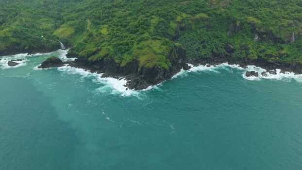 Aerial view of Bukit Pengilon cliffs and ocean waves Indonesia.