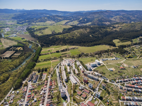 Aerial view of Namestovo featuring residential buildings green fields and a winding river against a backdrop of forested hills in Namestovo Zilina Region Slovakia. Aerial view of Namestovo featuring residential buildings green fields and a winding river against a backdrop of forested hills in Namestovo Zilina Region Slovakia.